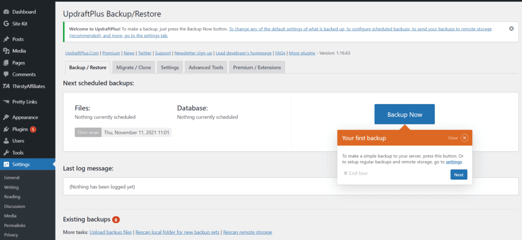 La página de configuración del plugin Updraft Plus en la administración de WordPress. Puede ver las opciones de copia de seguridad/restauración, migrar/clonar, configuración, herramientas avanzadas, premium/extensiones. También hay un cuadro naranja emergente que le pide que complete su primera copia de seguridad.